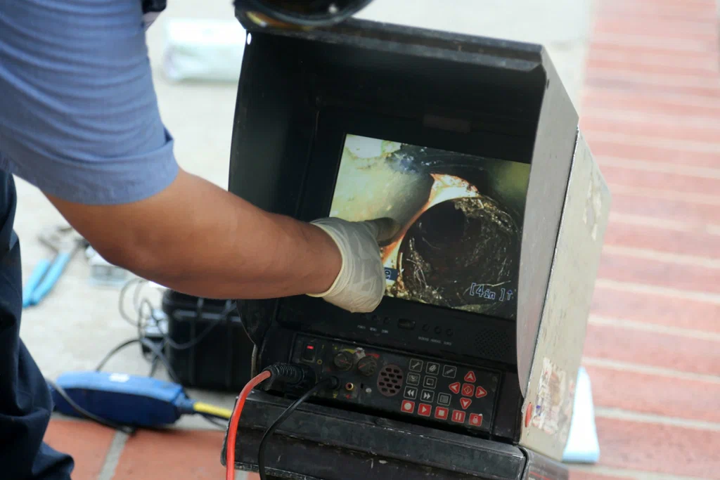 Technician viewing a drain inspection camera in Warrington
